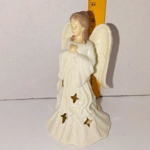 A porcelain candle holder angel
